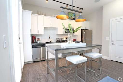 A modern kitchen with a stainless steel dishwasher and refrigerator.