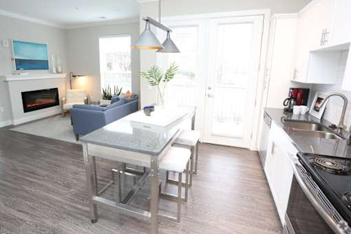 A kitchen with a table and chairs in the middle of the room.