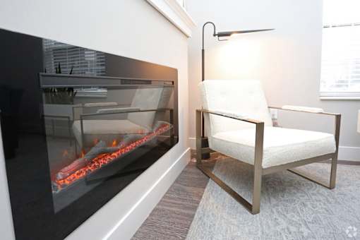 A modern living room with a fireplace and a chair.