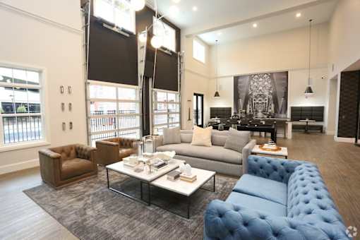 A modern living room with a blue tufted couch and a coffee table.