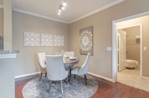 a dining room with a table and chairs at Century South Shore, League City, TX