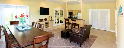 a kitchen and living room with a table and chairs at Chester Village Green Apartments, Chester, VA