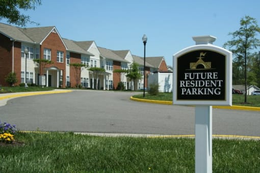 a sign for a future residential parking in front of a building at Chester Village Green Apartments, Virginia, 23831