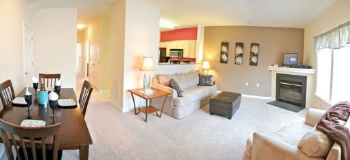 a living room with a fireplace and a dining table at Chester Village Green Apartments, Chester, 23831