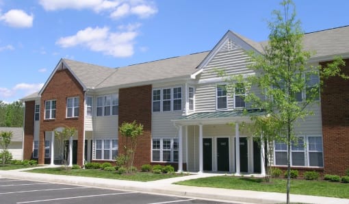 a large building with a street in front of it at Chester Village Green Apartments, Chester, VA, 23831