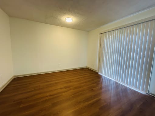 a bedroom with white walls and carpet