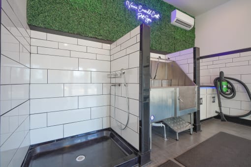 a bathroom with green astroturf on the ceiling