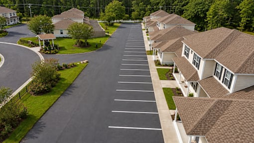 A long row of houses with a road in between.