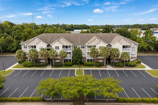 A large building with a parking lot in front of it.