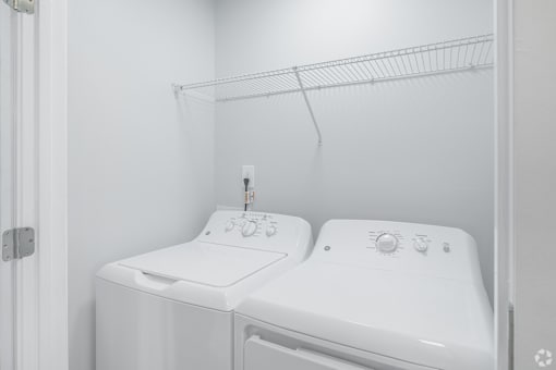 A white bathroom with a toilet and sink.
