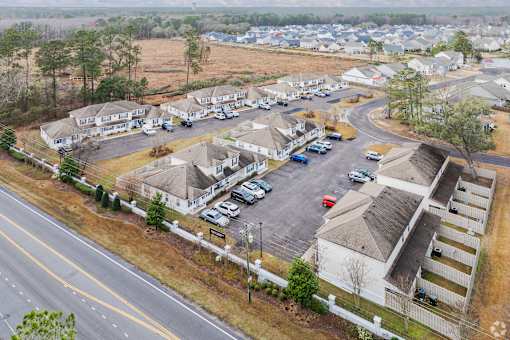 A bird's eye view of a residential area with houses and cars.