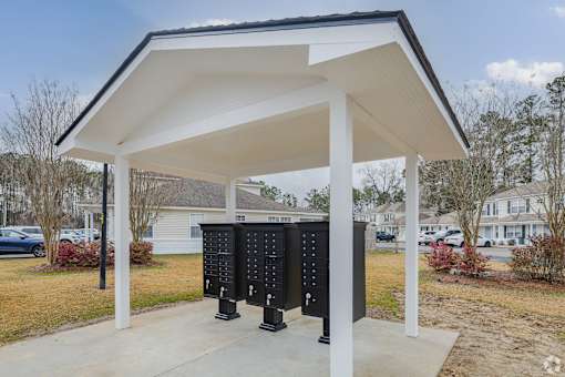 A white covered structure with two black panels in front.