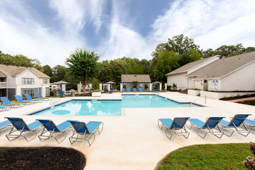our apartments have a resort style pool with blue chairs at Magnolia Place at Stockbridge Apartments, Stockbridge, GA