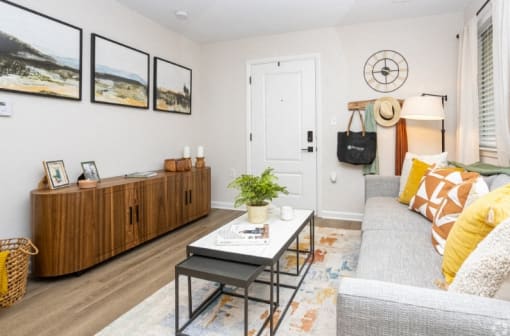 a living room with a gray couch and a coffee table