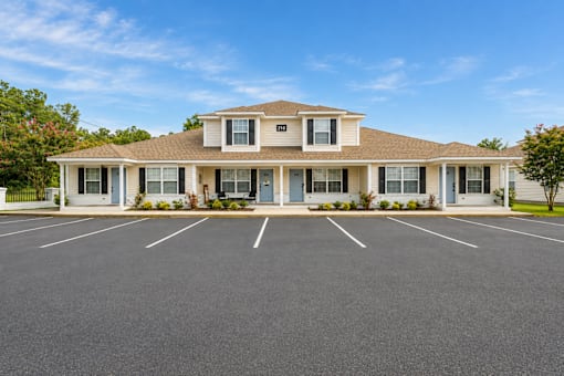 A building with a parking lot in front of it.