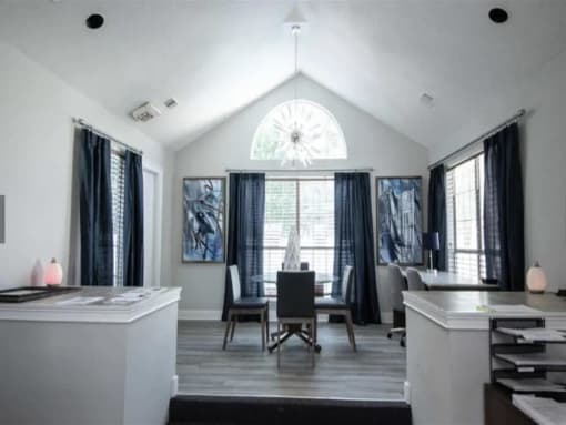 a white living room with a table and chairs and a window at The Sapphire, Decatur, Georgia