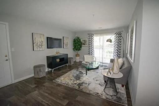 a living room with a couch and a television at The Sapphire, Georgia, 30035