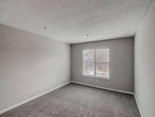 an empty living room with a window at The Sapphire, Decatur, 30035