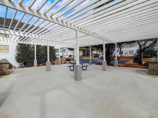 a covered patio with benches under a white canopy at The Sapphire, Decatur, Georgia
