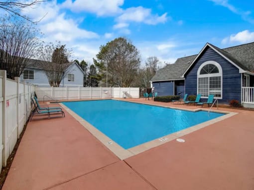 a swimming pool with a house and a fence around it at The Sapphire, Decatur, GA, 30035