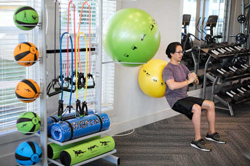 a man exercising in the gym at a health club at Century Mundy Mill Apartments, Oakwood 30566