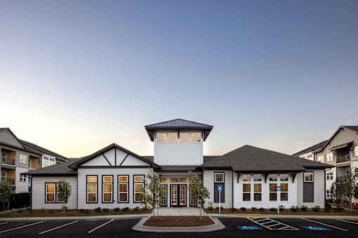 the exterior of a building with a parking lot at Century Mundy Mill Apartments, Georgia