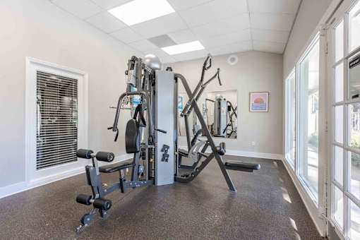 A well-equipped gym with a variety of machines and weights. at Grove at St. Andrews, Columbia, 29210