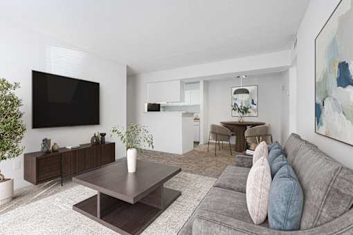 A modern living room with a grey couch and a wooden coffee table. at Grove at St. Andrews, South Carolina