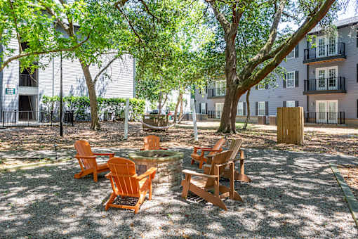 A sunny day at the park with chairs and tables.