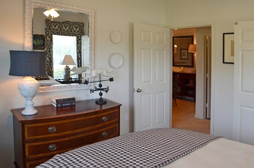 Bedroom with dressor mirror and entrance door at the Haven at Market Street Station, TN