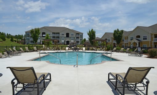 Spacious pool with comfortable lounge chairs at the Haven at Market Street Station Johnson City, TN