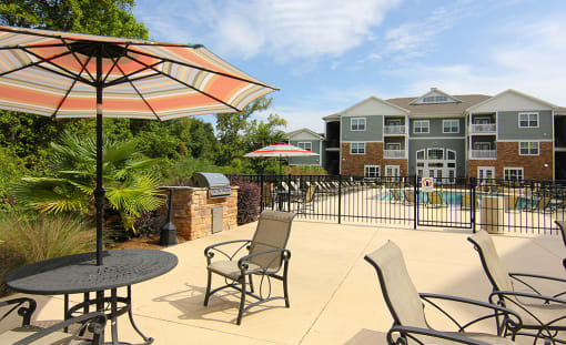Grills with chairs at the Haven at Reed Creek Apartments Martinez, GA