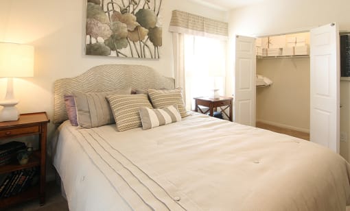Large bedroom in model home with bed and pillows at the Haven at Reed Creek Martinez, GA