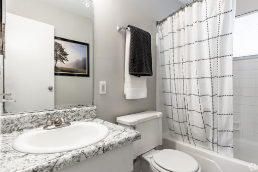 a bathroom with a sink toilet and bathtub at Summit Augusta, Augusta, 30909