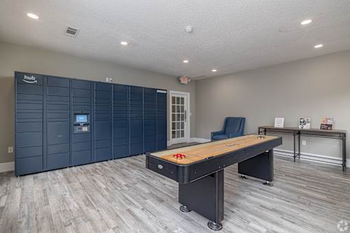 A room with a long table and a row of lockers.