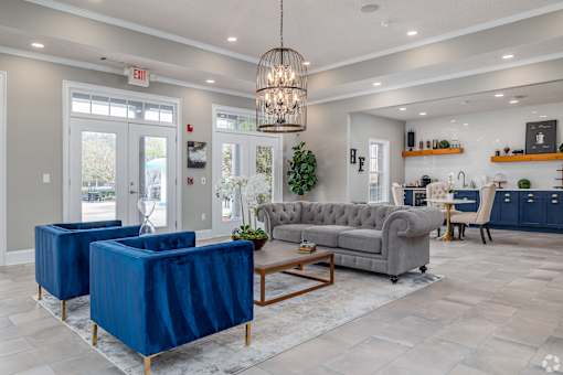 A living room with a grey sofa, a blue chair and a wooden coffee table.