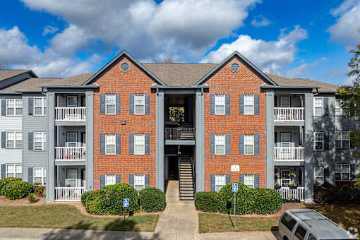 A large red brick building with a balcony on the second floor.