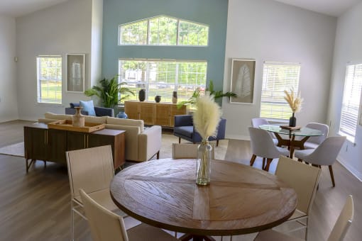 a living room and dining room with a table and chairs at Retreat at Savannah, Savannah, GA