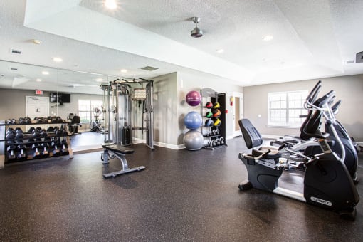 the gym at the district at highland village apartments