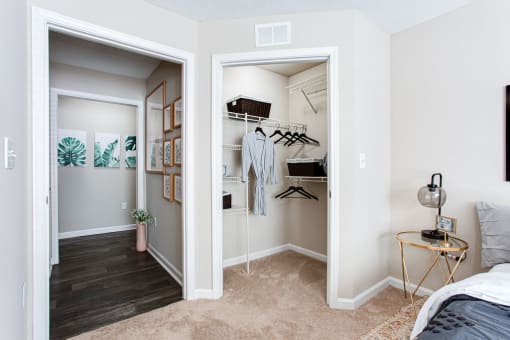 a bedroom with a closet and a bed and a mirror