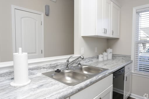 Kitchen sink and white cabinets at Highborne Augusta, GA