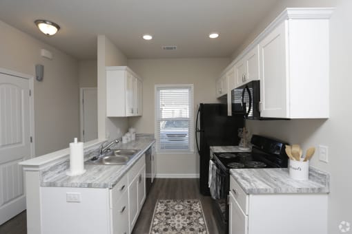 Spacious kitchen with white cabinets at Highborne apartments Augusta, GA