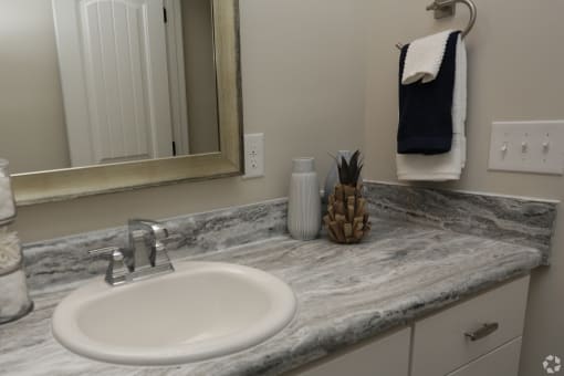 Spacious bathroom with white cabinets and tub at HIghborne apartments Augusta, GA