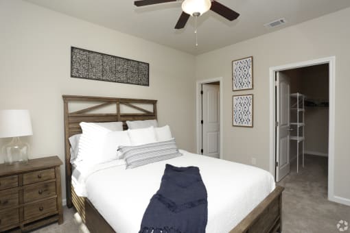 Spacious bedroom model apartment with queen bed at Highborne apartments in Augusta, GA