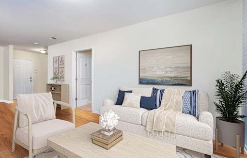 a living room with a white couch and a coffee table