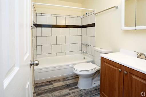 A bathroom with a white toilet, a white sink, and a white bathtub.