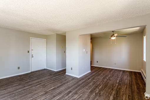 A room with wooden floors and white walls.