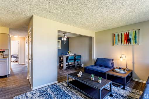 A living room with a blue couch and a coffee table.