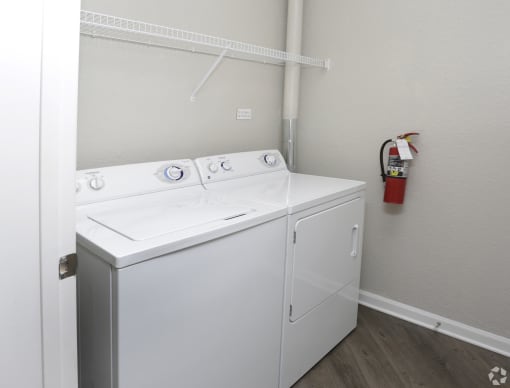 a washer and dryer in a room with a fire hydrant