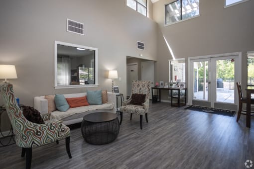 a living room with a couch and chairs and a table